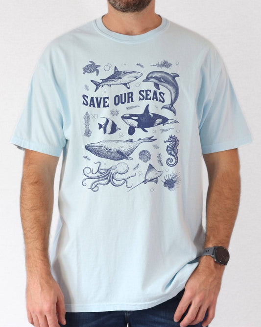 Man wearing a chambray "Save Our Seas" shirt with a retro sea animal graphic collage.