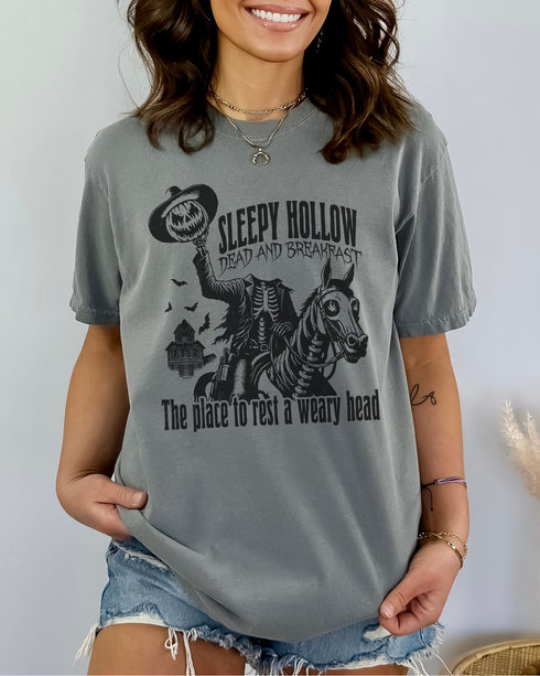 Model wearing gray color shirt with 'Sleepy Hollow Dead And Breakfast - The Place To Rest A Weary Head' graphic design