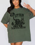 Model wearing moss color shirt with 'Sleepy Hollow Dead And Breakfast - The Place To Rest A Weary Head' graphic design