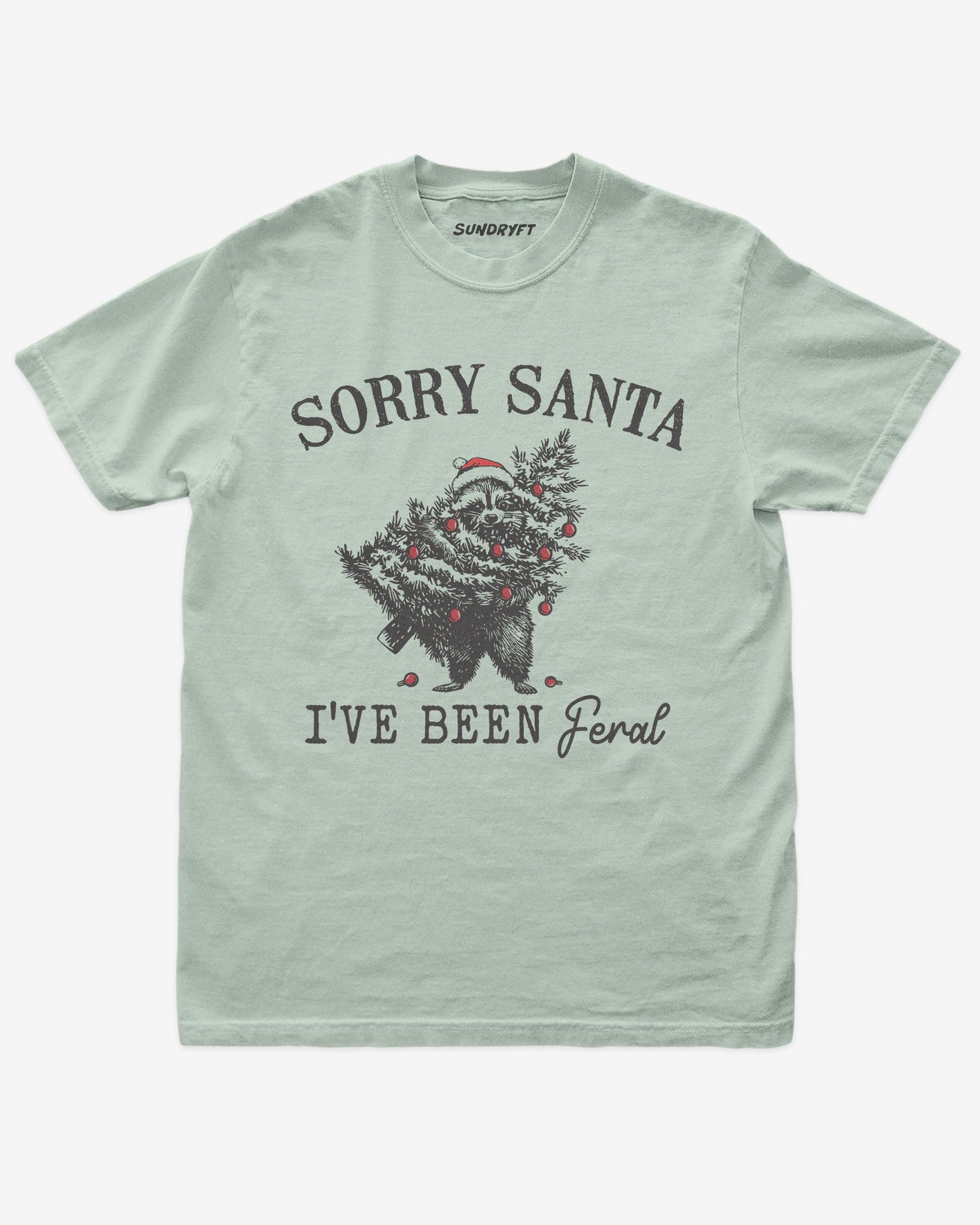 Sorry Santa I've Been Feral shirt in bay with raccoon eating Christmas tree graphic