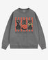 Flat lay gray-colored 'Spooky And Cute' sweatshirt with retro Halloween graphic of three black cats and a pumpkin.