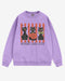 Flat lay orchid-colored 'Spooky And Cute' sweatshirt with retro Halloween graphic of three black cats and a pumpkin.