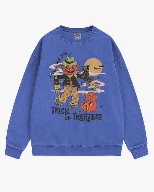 Flat lay flo blue Halloween sweatshirt reading โSupport Your Local Trick Or Treatersโ with retro graphic of scarecrow, owl, and pumpkins.