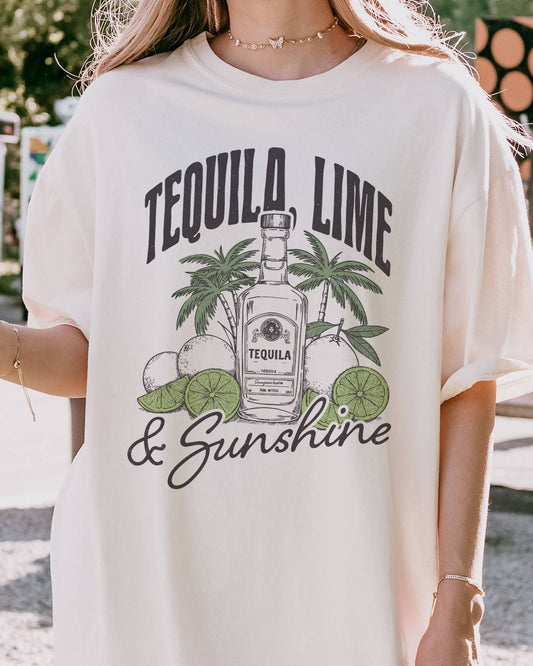 Close-up of model wearing ivory color shirt with 'Tequila Lime And Sunshine' funny retro graphic design