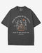 They’re Burning All The Witches Shirt – flat lay graphite tee with funny retro skeletons dancing in fire graphic