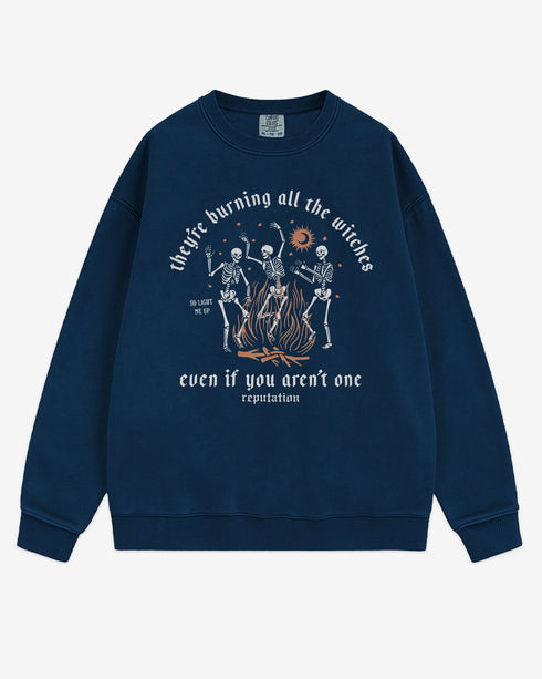 They’re Burning All The Witches Sweatshirt flat lay true navy color retro graphic with skeletons dancing in fire