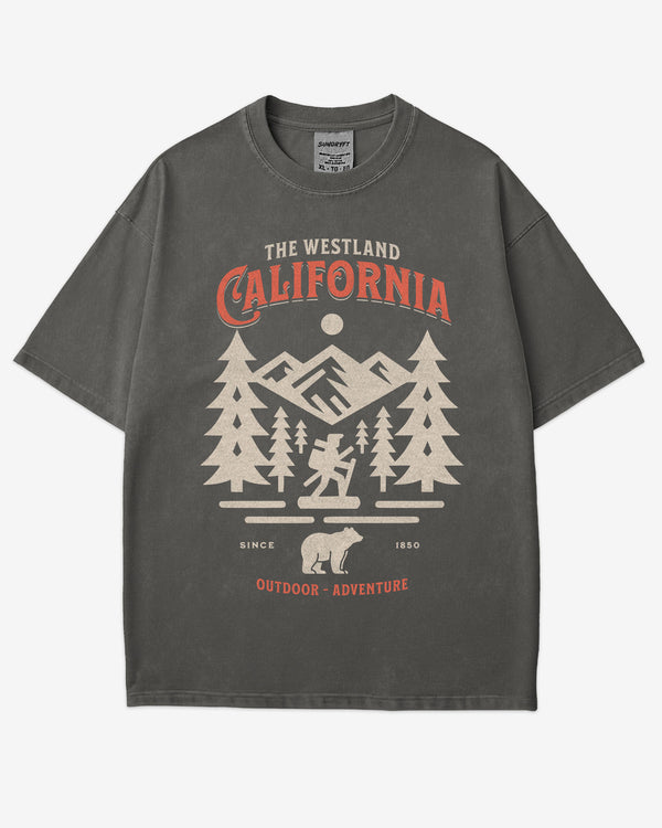 Flat lay pepper Westland California Outdoor Adventure shirt with a retro vector graphic of a hiker, bear, and mountains.
