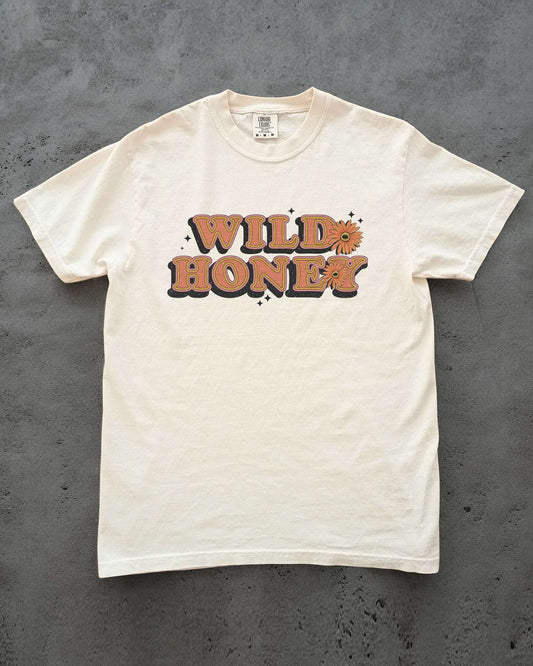 Flat Lay Wild Honey shirt laying on concrete in ivory color