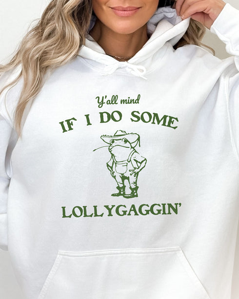 Close-up of a white hoodie featuring a funny retro country frog graphic and the quote 'Y'all Mind If I Do Some Lollygaggin''.