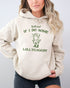 Woman wearing a sand beige hoodie featuring a funny retro country frog graphic and the quote 'Y'all Mind If I Do Some Lollygaggin''.