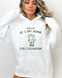 Woman wearing a white hoodie featuring a funny retro country frog graphic and the quote 'Y'all Mind If I Do Some Lollygaggin''.