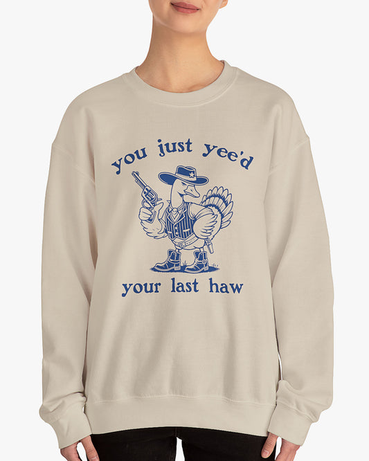 Woman wearing sand beige 'You Just Yeed Your Last Haw' sweatshirt with funny retro cowboy goose graphic
