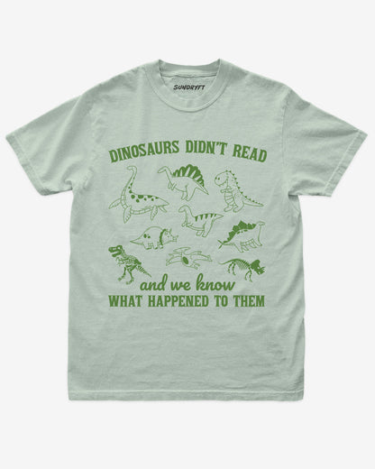 Dinosaurs Didn't Read And We Know What Happened shirt in bay with dinosaur collage doodle graphic