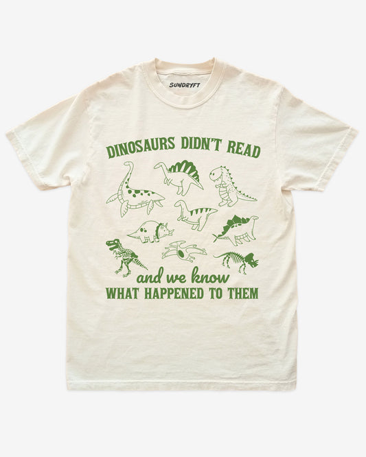 Dinosaurs Didn't Read And We Know What Happened shirt in ivory with dinosaur collage doodle graphic