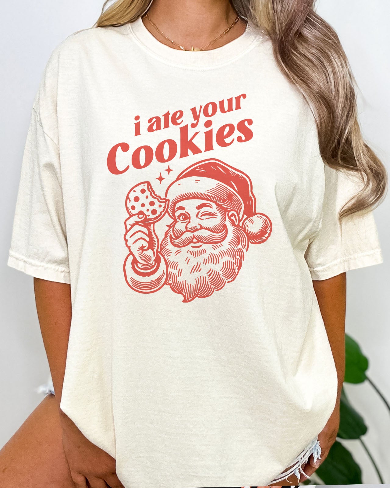 Woman wearing funny retro Santa Clause graphic tee with the quote I Ate Your Cookies