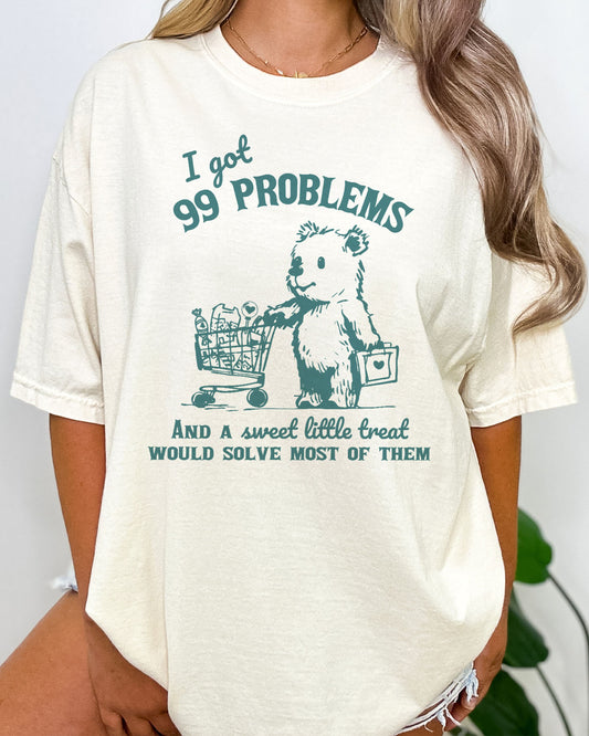 I Got 99 Problems Shirt in natural color with the quote I Got 99 Problems And A Sweet Little Treat Would Solve Most Of Them
