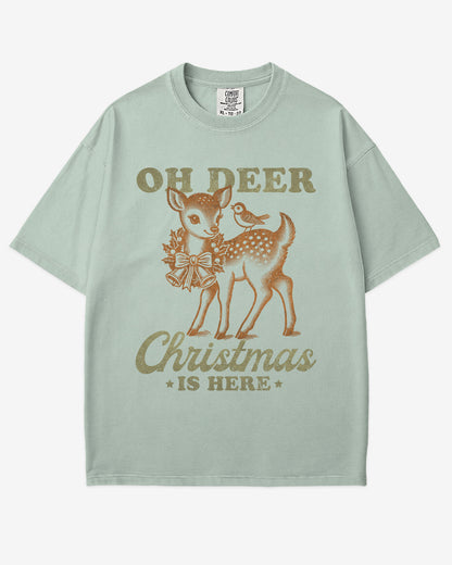Oh Deer Christmas Is Here shirt in bay color with retro graphic of a little reindeer