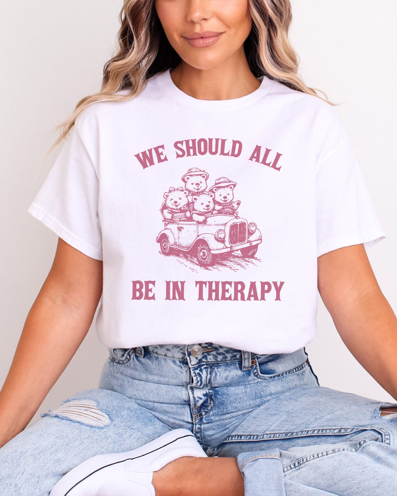 Funny therapy shirt in white color with the quote "We should all be in therapy"