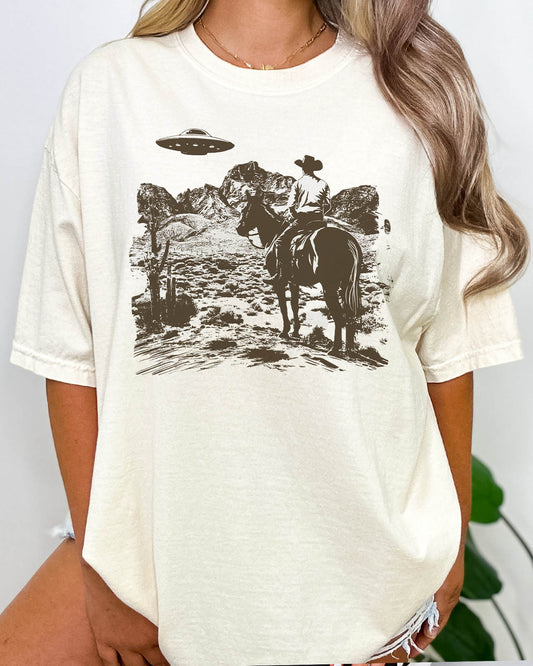 Woman wearing a retro UFO Western graphic shirt in natural color