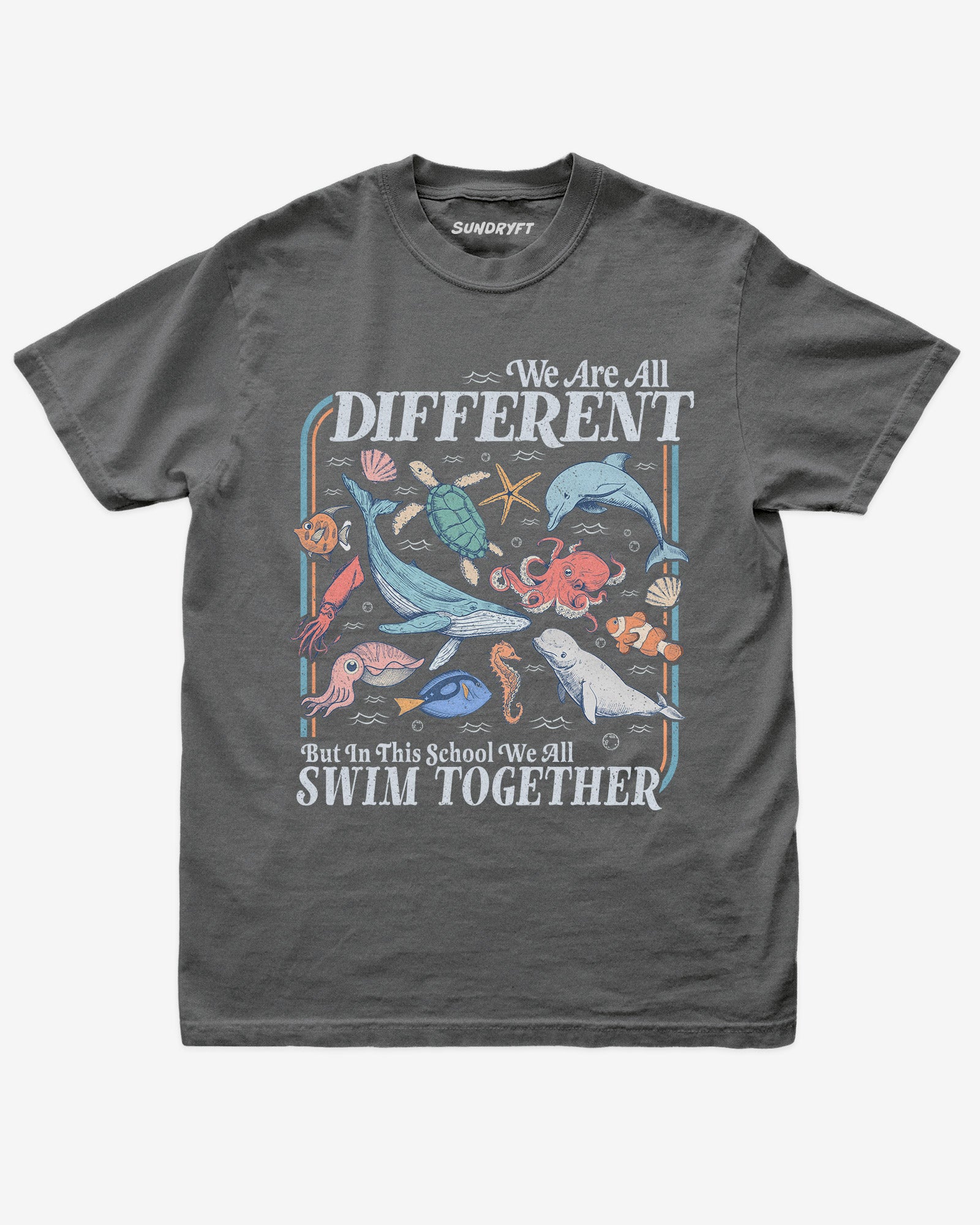 Flat lay of pepper We Are All Different But In This School We All Swim Together Shirt with cute retro ocean animal design