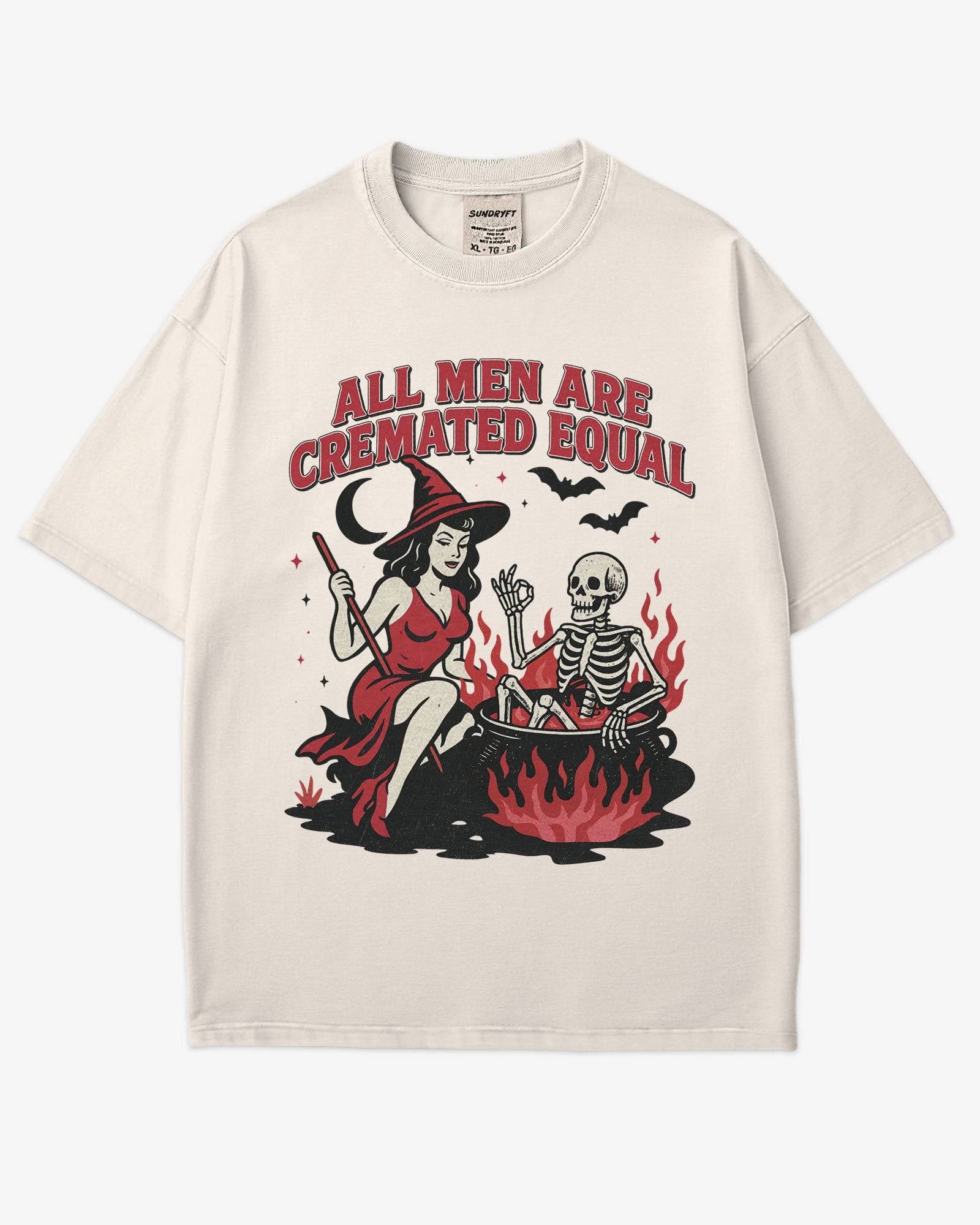 Flat lay ivory “All Men Are Cremated Equal” shirt with a retro Halloween graphic of a witch stirring a skeleton in a cauldron.