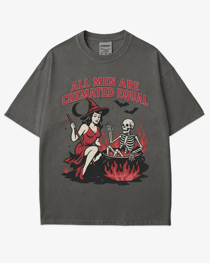 Flat lay pepper “All Men Are Cremated Equal” shirt with a retro Halloween graphic of a witch stirring a skeleton in a cauldron.