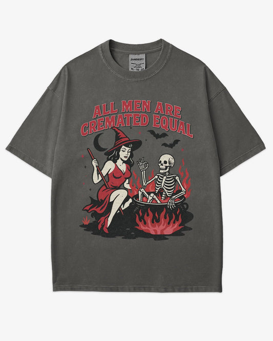 Flat lay pepper “All Men Are Cremated Equal” shirt with a retro Halloween graphic of a witch stirring a skeleton in a cauldron.
