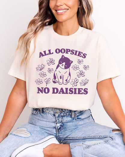 Model wearing natural color shirt with 'All Oopsies No Daisies' graphic design