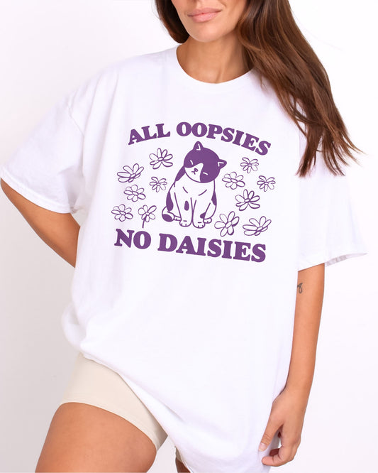 Model wearing white color shirt with 'All Oopsies No Daisies' graphic design