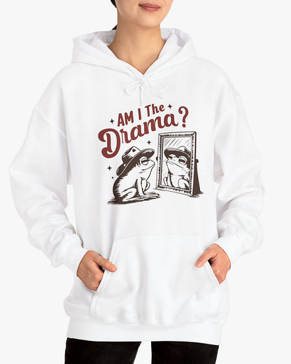 Woman wearing a white 'Am I The Drama?' hoodie featuring a funny retro cowboy frog looking at himself in the mirror graphic.