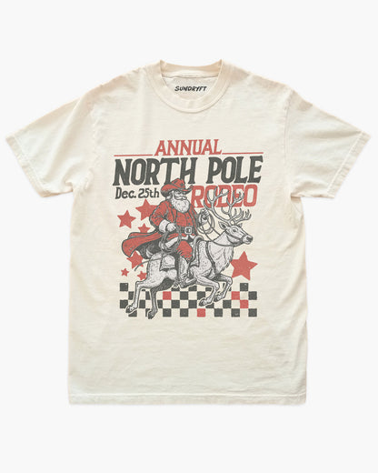 Annual North Pole Rodeo shirt in ivory with cowboy Santa riding reindeer graphic