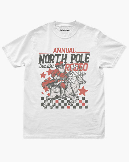 Annual North Pole Rodeo shirt in white with cowboy Santa riding reindeer graphic