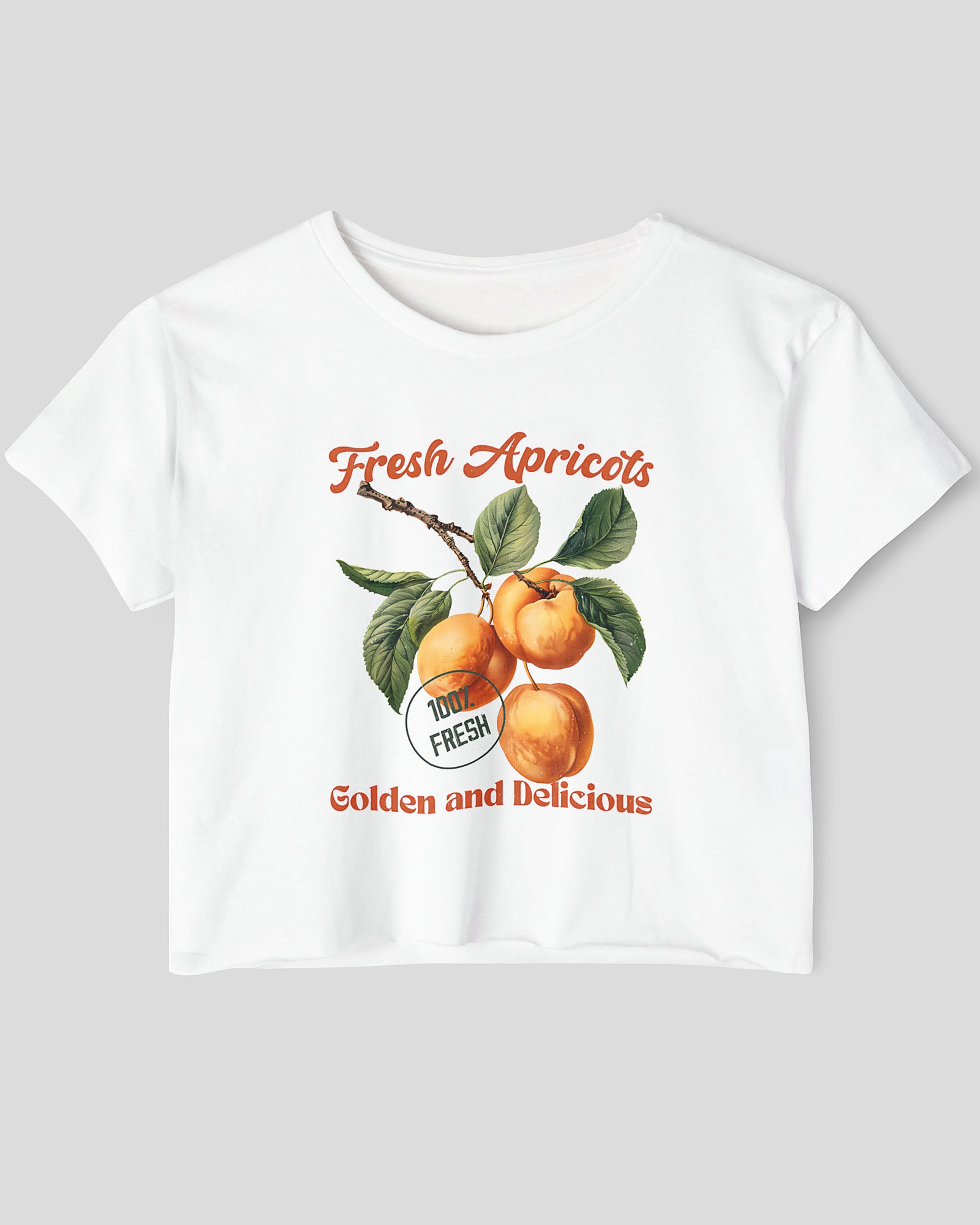 Flat lay white crop top featuring a retro apricots fruit graphic in a vintage commercial style.
