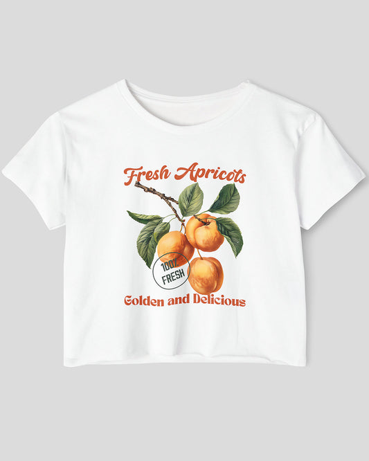 Flat lay white crop top featuring a retro apricots fruit graphic in a vintage commercial style.