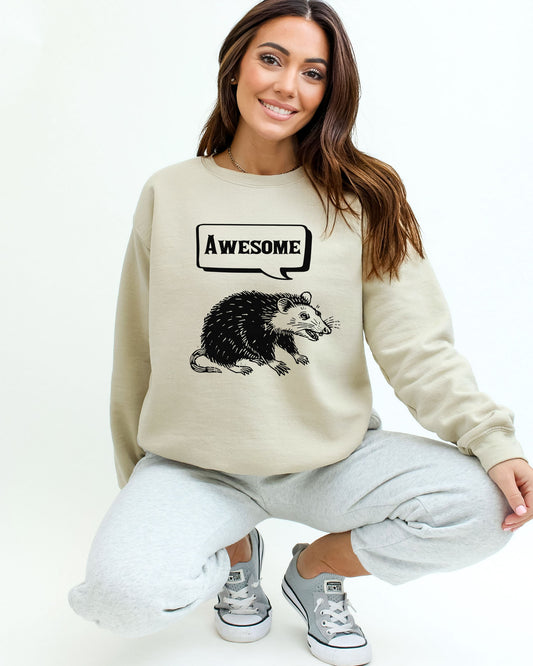Model wearing sand color sweatshirt with 'Awesome Opossum' graphic design