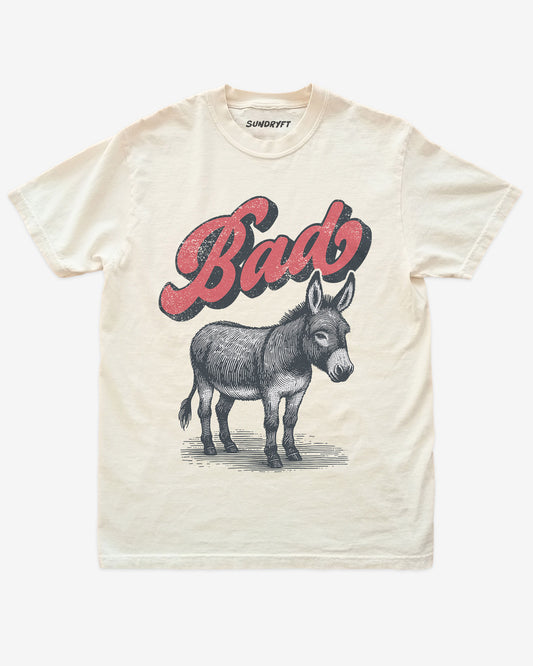 Ivory “Badass Donkey” funny pun retro graphic shirt flat lay.