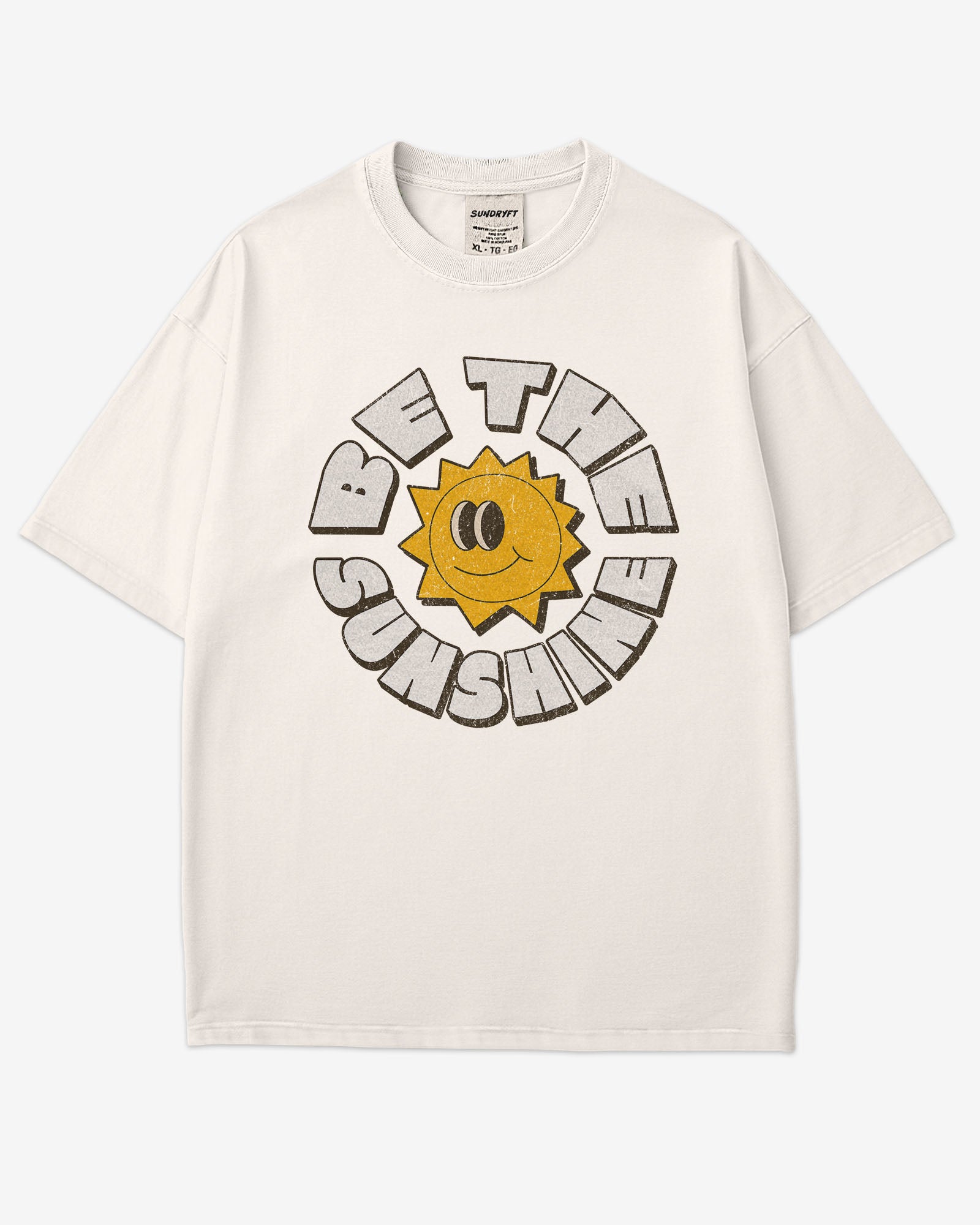 Flat lay ivory-colored Be The Sunshine shirt with a retro boho sun graphic.