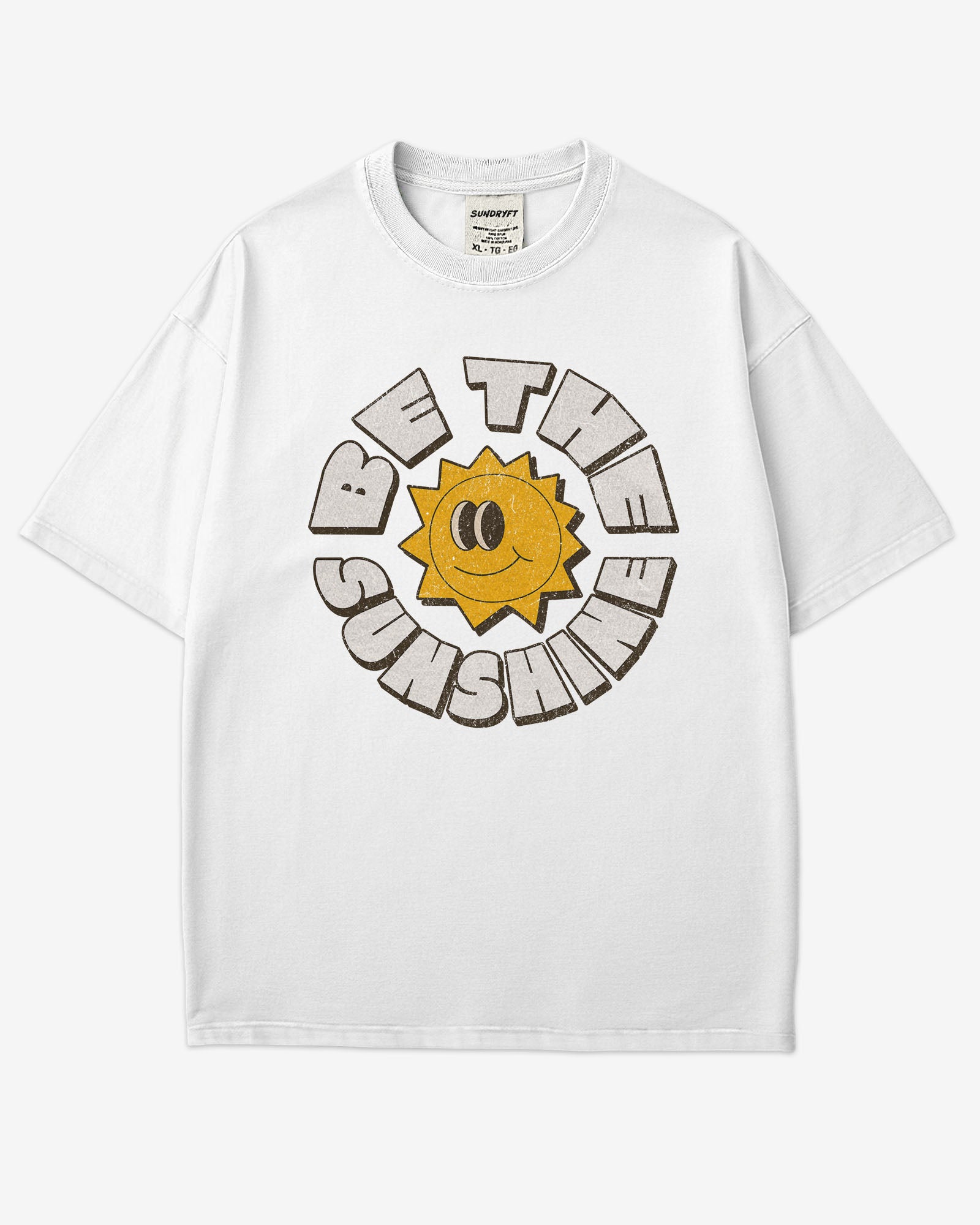 Flat lay white-colored Be The Sunshine shirt with a retro boho sun graphic.