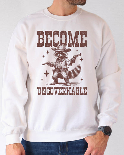 Man wearing a white sweatshirt with a retro cowboy raccoon and the text “Become Ungovernable.”