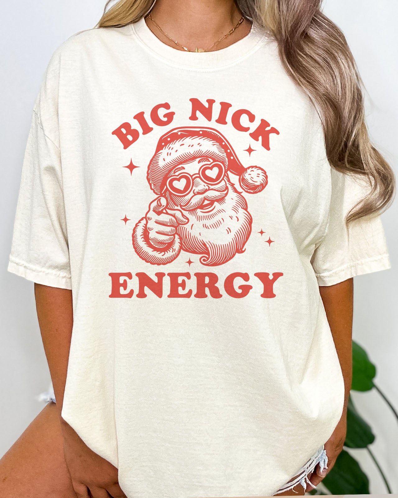 Woman wearing funny Big Nick Energy retro graphic shirt in natural beige color
