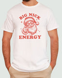 Man wearing a 'Big Nick Energy' shirt in natural beige with a retro Santa Claus graphic and unisex fit, funny Christmas design.