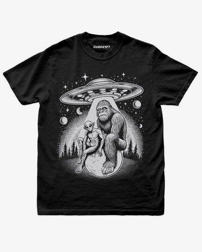 Bigfoot Alien UFO Shirt on black tee with retro cosmic forest design