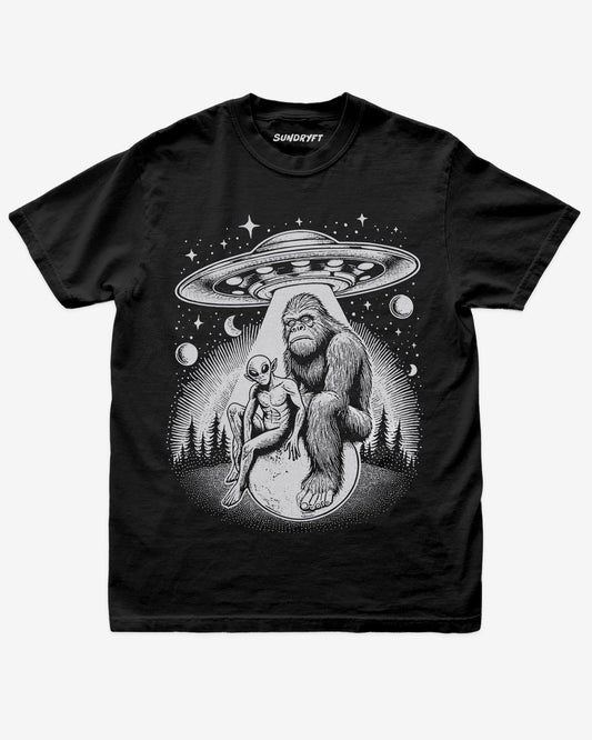 Bigfoot Alien UFO Shirt on black tee with retro cosmic forest design