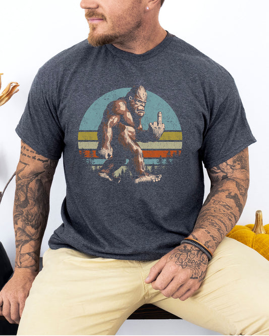 Model wearing dark heather color shirt with 'Bigfoot Showing Middle Finger' graphic design
