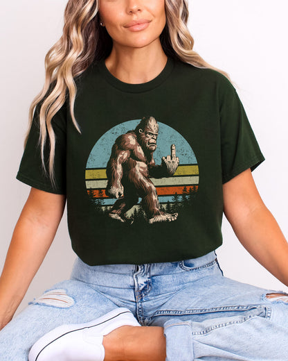 Model wearing forest green color shirt with 'Bigfoot Showing Middle Finger' graphic design