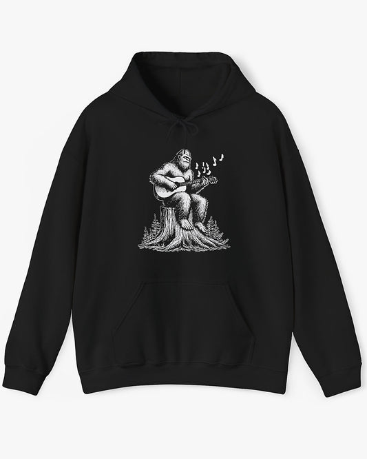 Flat lay black hoodie with funny retro Bigfoot playing guitar graphic
