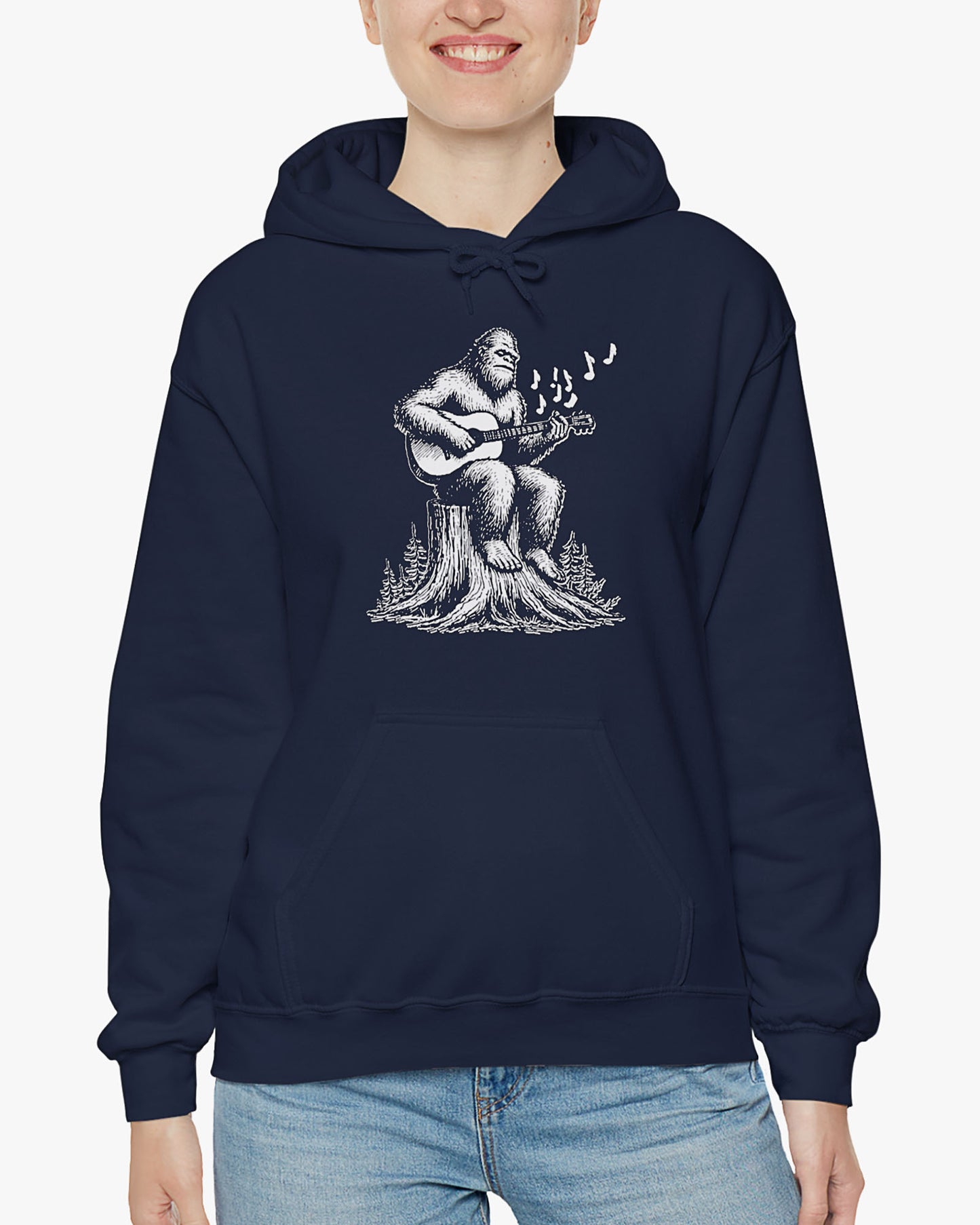 Woman wearing navy blue hoodie with funny retro Bigfoot playing guitar graphic