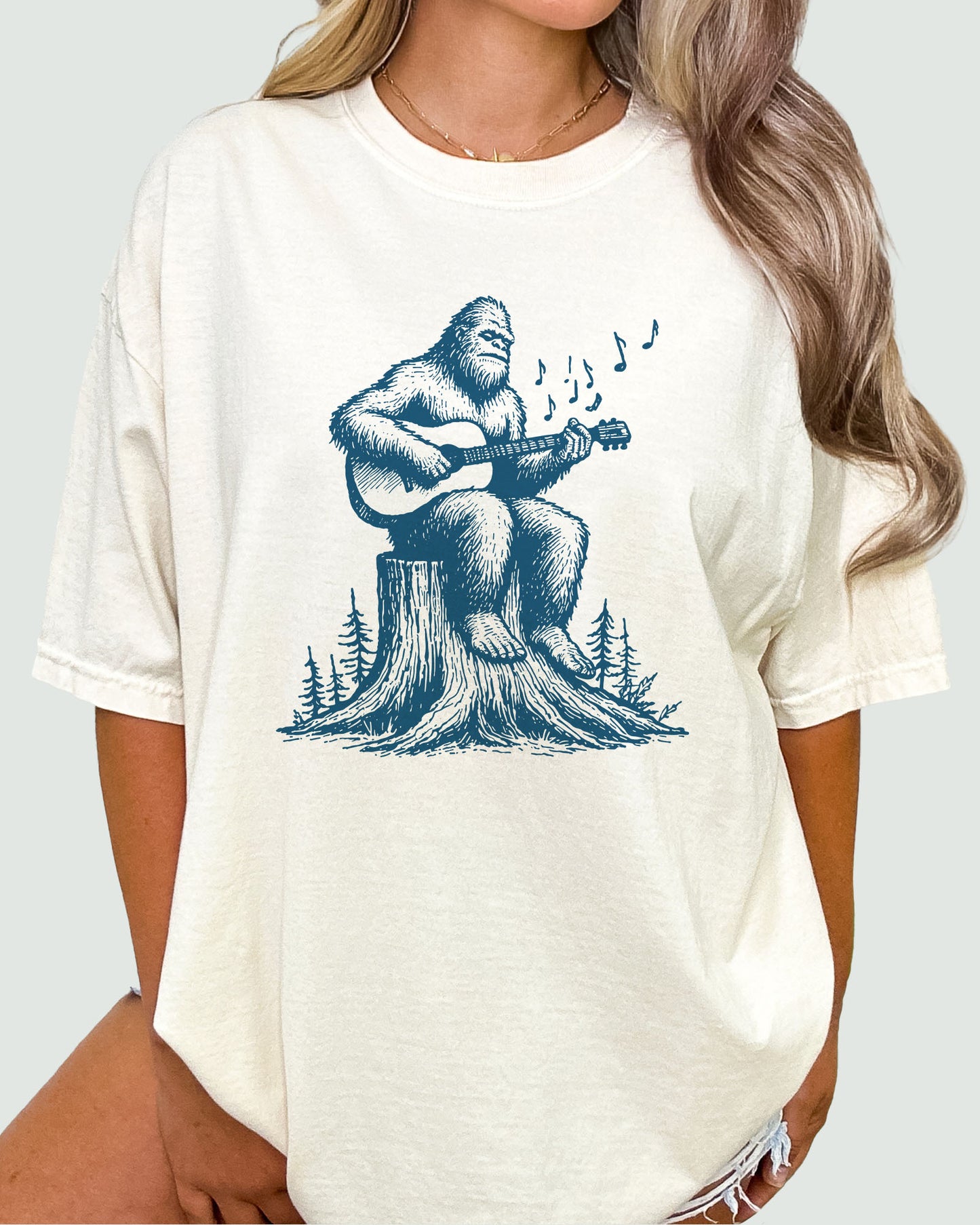 Bigfoot Playing Guitar Shirt natural color tee with funny retro graphic of Bigfoot playing guitar