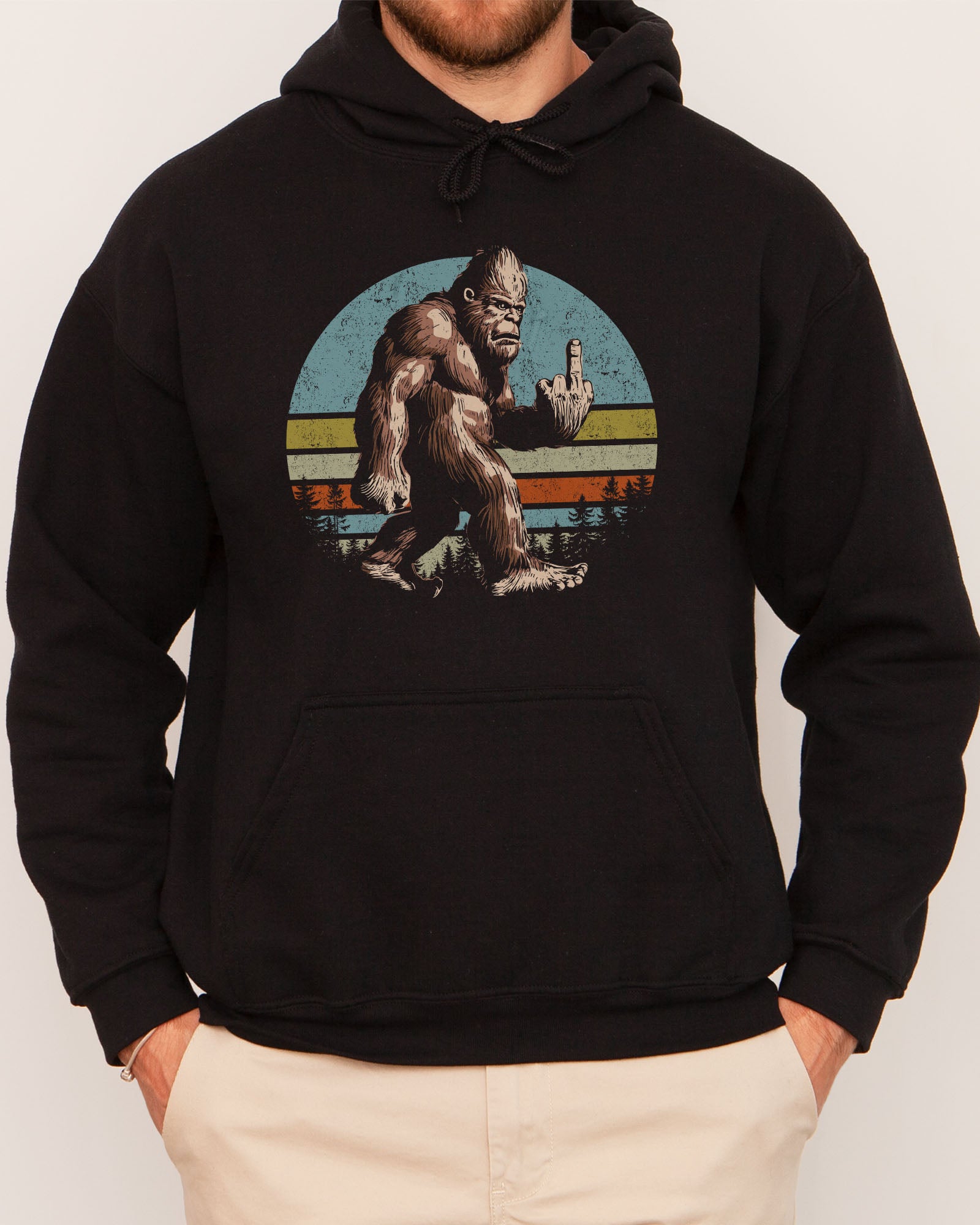Man wearing a black hoodie with a funny retro graphic of Bigfoot showing the middle finger.