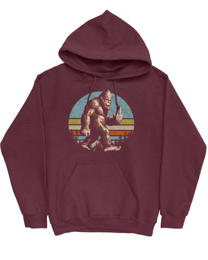 Flat lay of a maroon hoodie with a funny retro graphic of Bigfoot showing the middle finger.